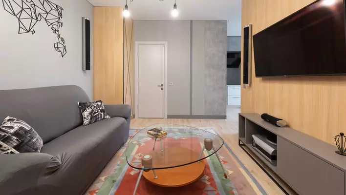 living room interior with sofa near table and tv