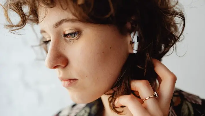 Woman with Airpods on Her Ear